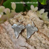 Sterling silver ivy leaf drop earrings on natural bark background