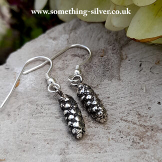 Sterling silver alder flower drop earrings on natural background