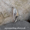 Sterling silver crab claw pendant with silver belcher chain on natural stone background