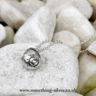 sterling silver necklace shell pendant with silver belcher chain on natural pebble background