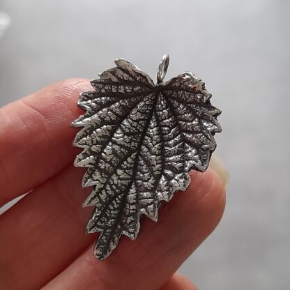 Sterling-silver-stinging-nettle-pendant-in-hand-front