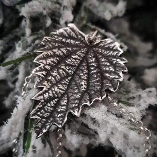 Sterling-silver-stinging-nettle-pendant-on-snowy-grass