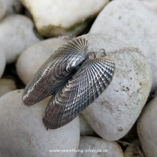 Double-Angel-Wing-Pendant-on-rock